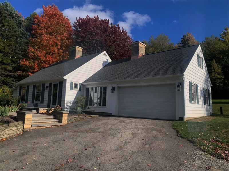White House With Green Shutters and New Roof By Roofs By Bryan