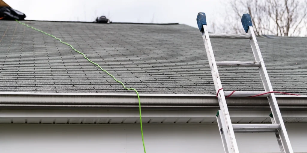 Aluminum ladder leaning against a residential home during a roofing inspection in Hamburg, NY