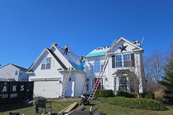 Roofing crew installing new underlayment on a residential home in Western New York during a full roof replacement