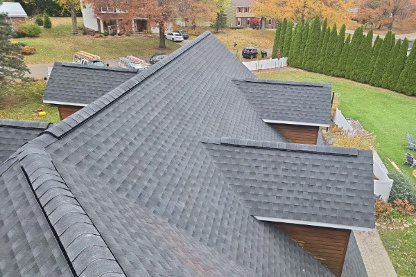 Aerial view of a completed asphalt shingle roof replacement showing multiple angles, dormers, and valleys in Western New York