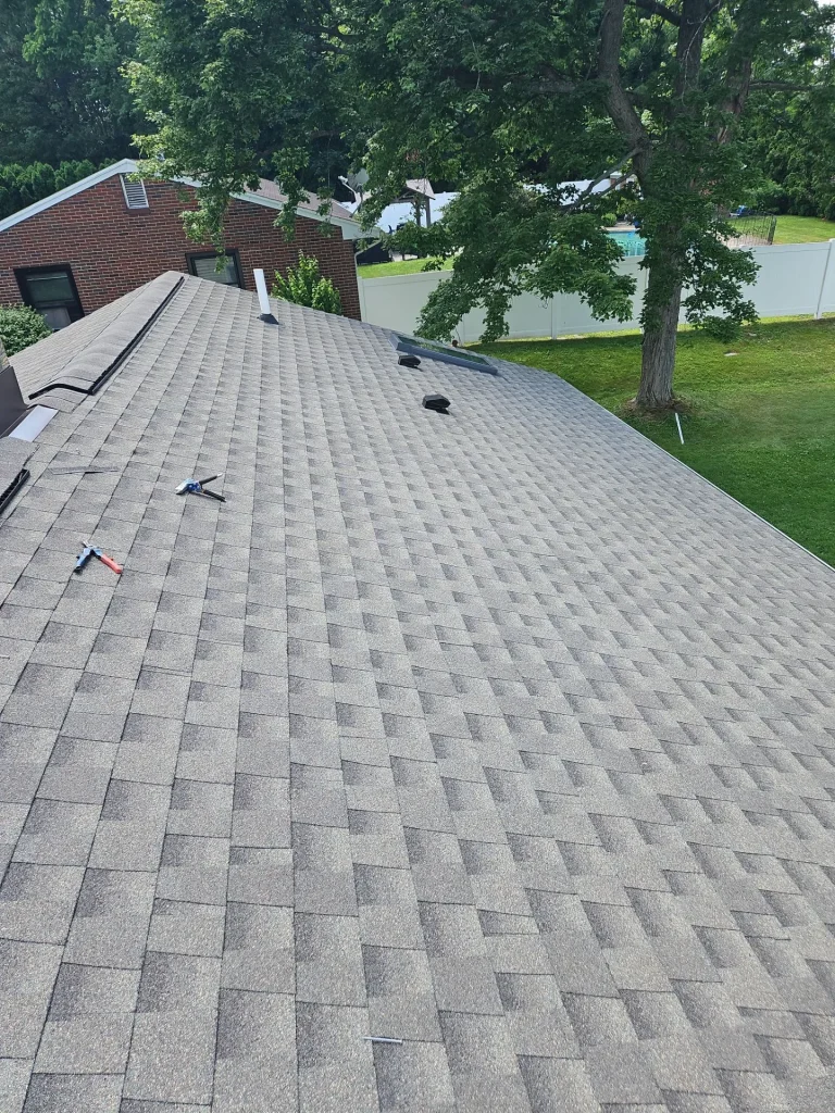 New GAF shingle roof with replacement skylight installed on an Angola, NY home