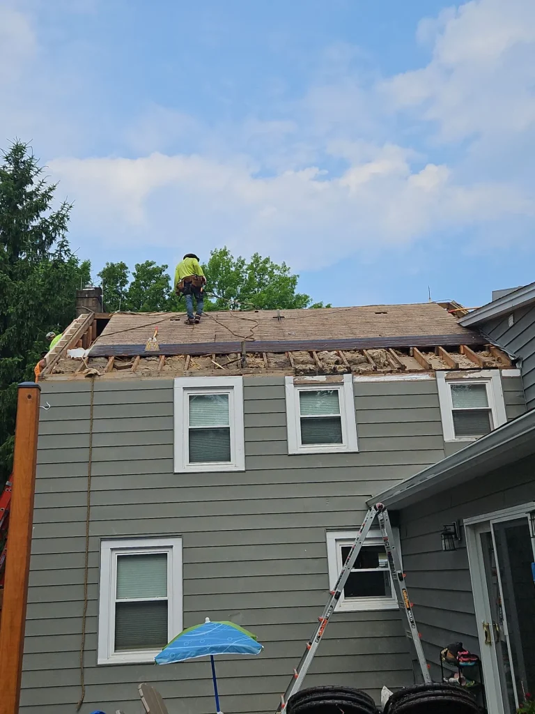 Roofing crew rebuilding the eaves during a residential roof replacement in Hamburg, NY