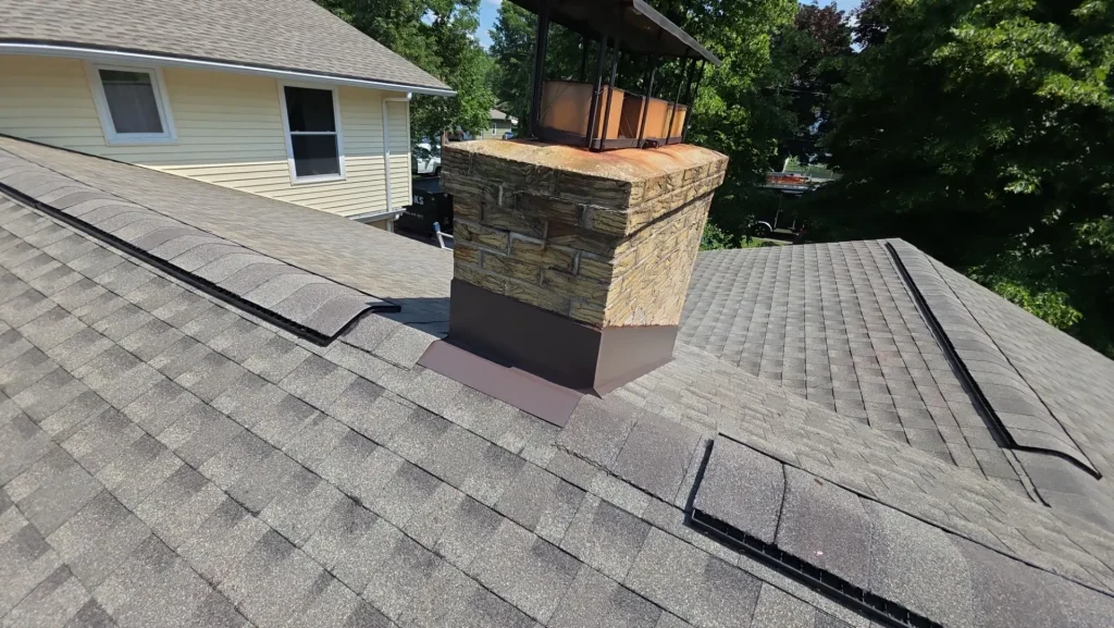 GAF HDZ Weathered Wood shingles with finished chimney flashing on an Angola, NY home