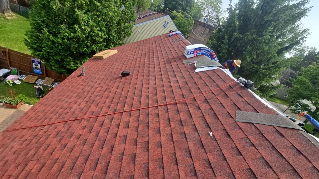 GAF HDZ Patriot Red shingles being installed on a residential roof in Hamburg, NY