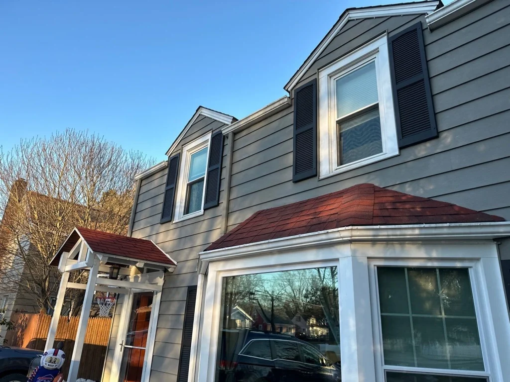 Close-up before photo showing original gutters and roofline on a Hamburg, NY home