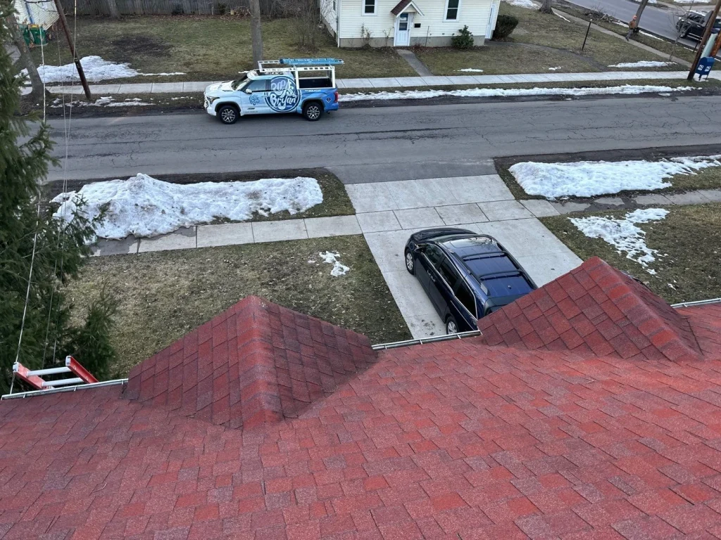 Before photo of aging red shingle roof prior to roof and eave replacement in Hamburg, NY