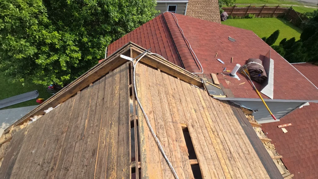 Exposed wood roof decking during roof replacement and eave repairs in Hamburg, NY